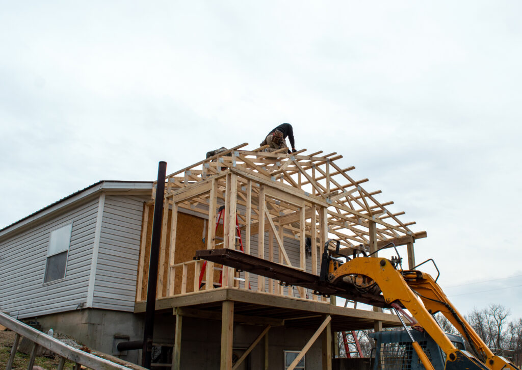 Home Additions - Carpenters on the roof of new building addition