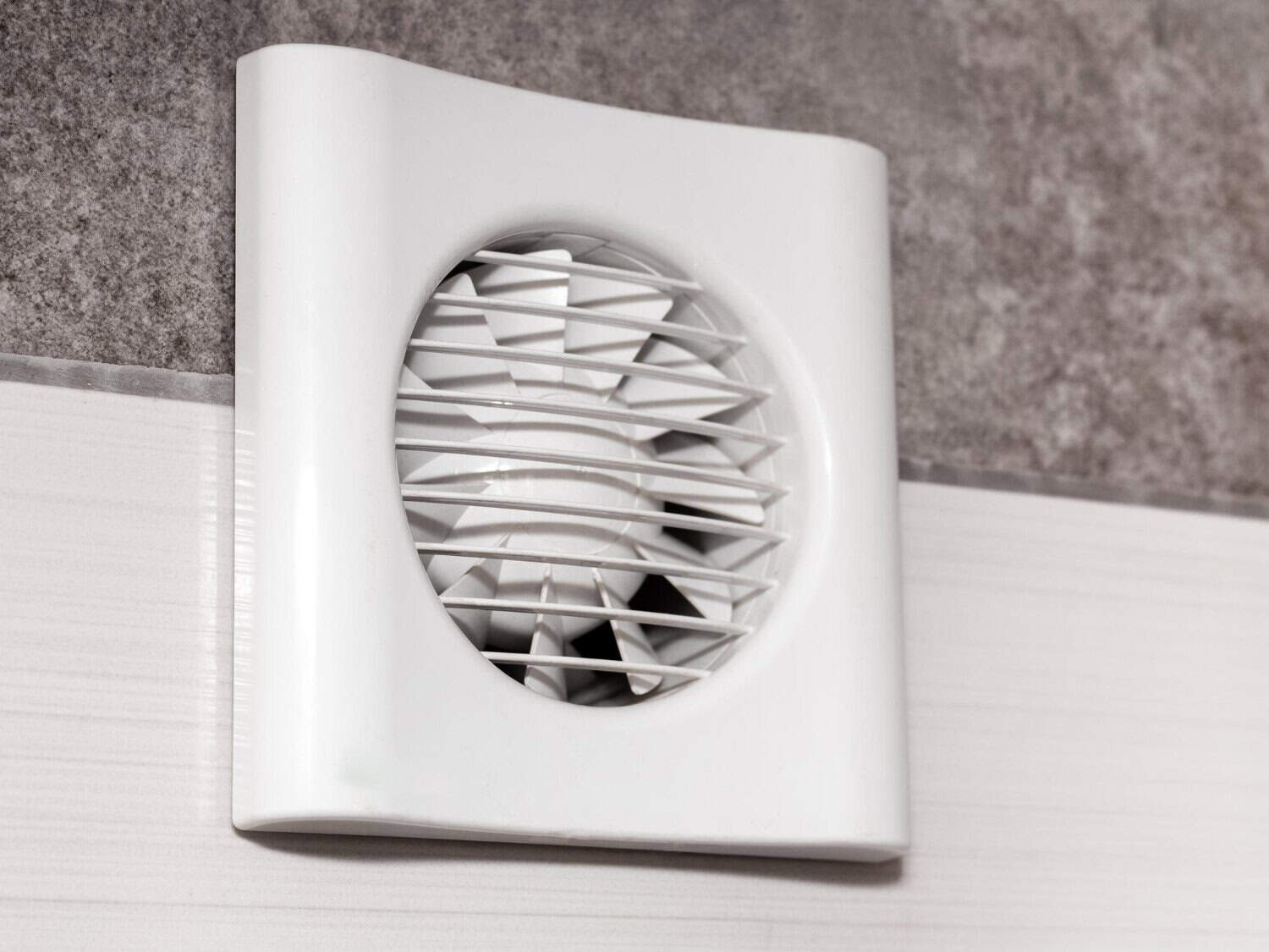 Bathroom exhaust fan mounted on a wall, designed to improve ventilation and reduce moisture in residential spaces.