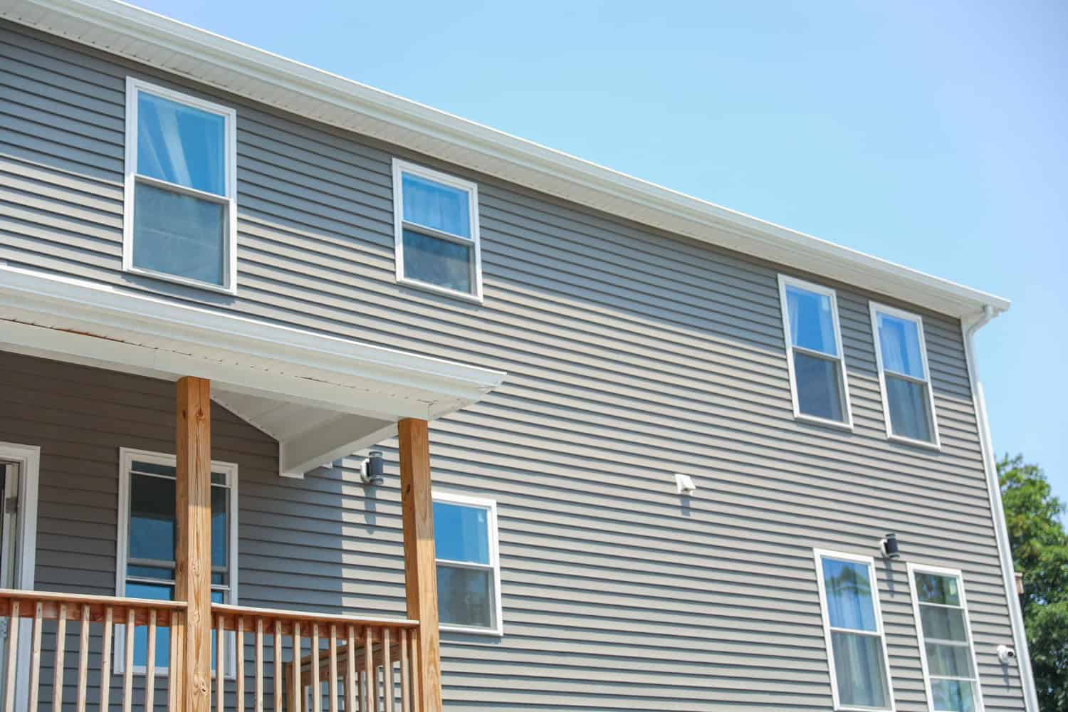 Residential siding with multiple windows, showcasing a modern design suitable for home improvement and protection against weather elements.
