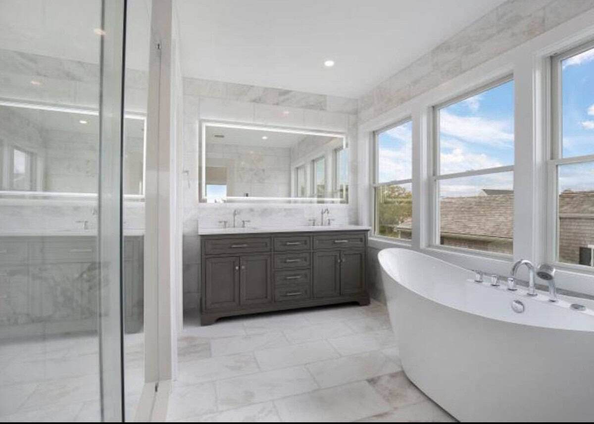 Finished primary bathroom remodel by Coast Carpentry in Hyannis with a tiled walk-in shower